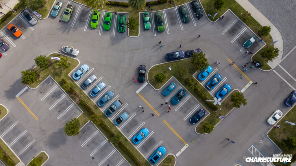 Drone shot showing multiple Porsche mainly in green and blue shades