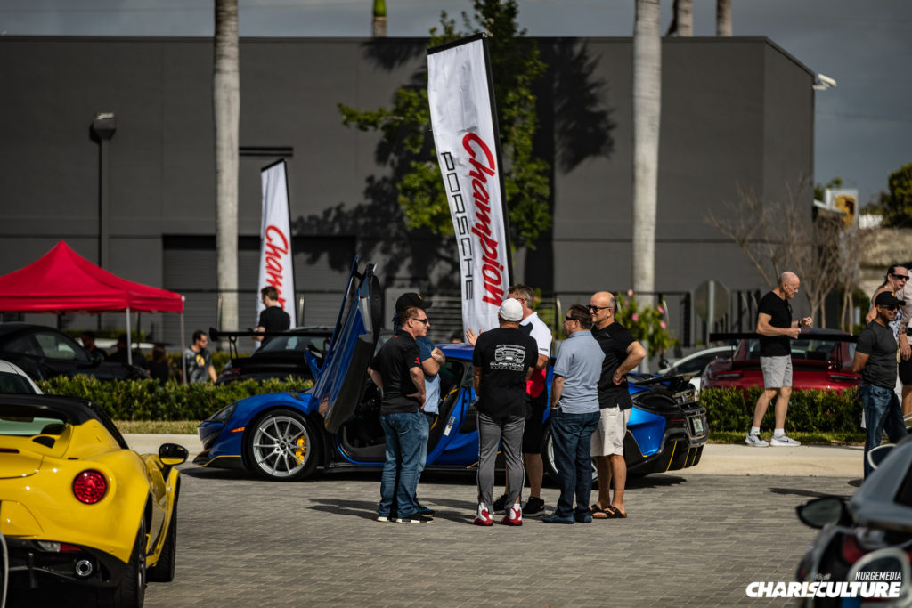 Group of enthusiasts talking at Cars & Brunch 4 at Champion Porsche